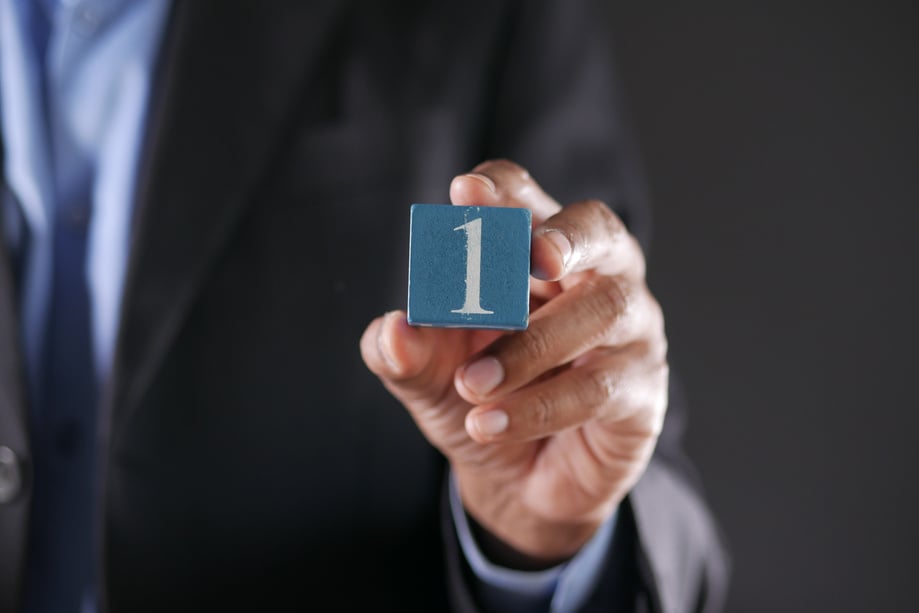 A Close-Up Shot of a Person Holding a Block with a Number